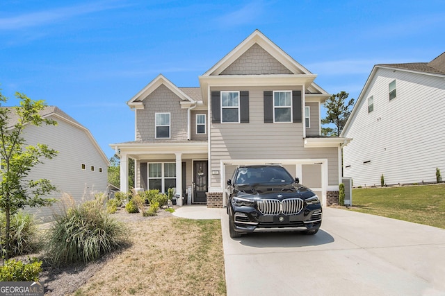 craftsman-style house with a porch, brick siding, a front lawn, concrete driveway, and an attached garage
