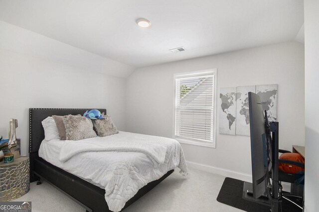 carpeted bedroom with baseboards, visible vents, and lofted ceiling