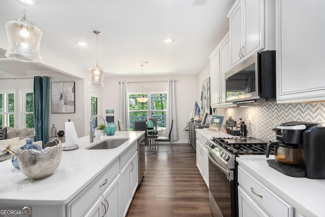 kitchen featuring a sink, light countertops, backsplash, and stainless steel appliances