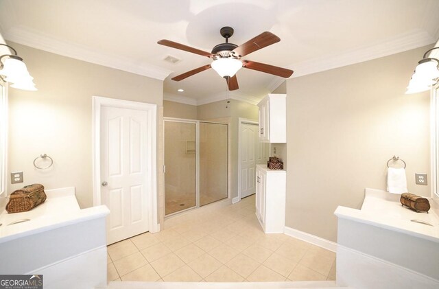 bathroom featuring ceiling fan, a shower stall, two vanities, tile patterned floors, and ornamental molding