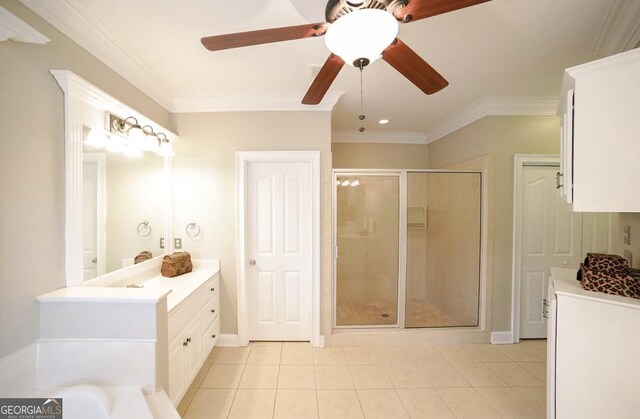 bathroom featuring tile patterned flooring, crown molding, vanity, a ceiling fan, and a stall shower