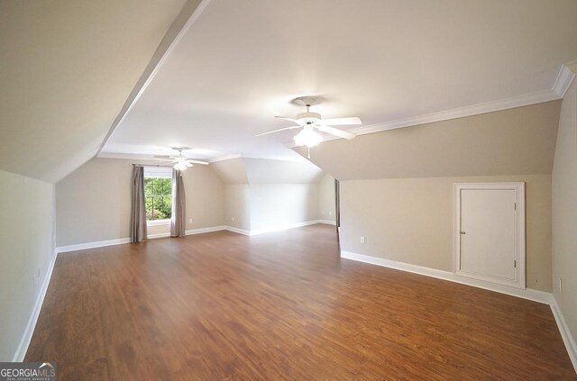 bonus room featuring ceiling fan, vaulted ceiling, baseboards, and dark wood-type flooring