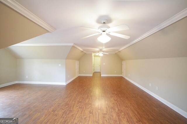 additional living space with a ceiling fan, baseboards, wood finished floors, and lofted ceiling