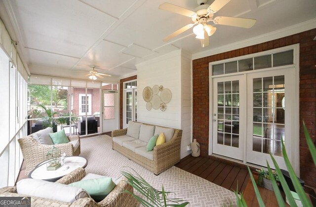 sunroom / solarium featuring french doors, a ceiling fan, and an outdoor hangout area