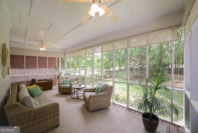sunroom / solarium featuring a healthy amount of sunlight, ceiling fan, and an outdoor hangout area
