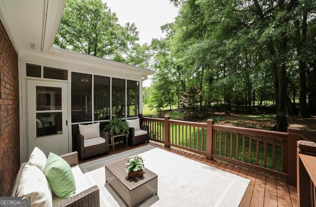 wooden terrace featuring outdoor lounge area and a sunroom