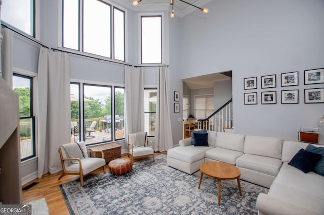 1745 Stripling Chapel Rd, Carrollton, GA 30116 - living area with light wood-style floors, a high ceiling, and stairway