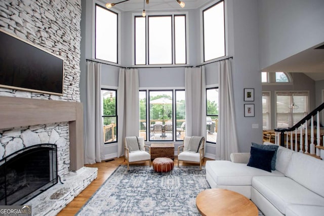 1745 Stripling Chapel Rd, Carrollton, GA 30116 - living area with wood finished floors, a high ceiling, a premium fireplace, and stairway
