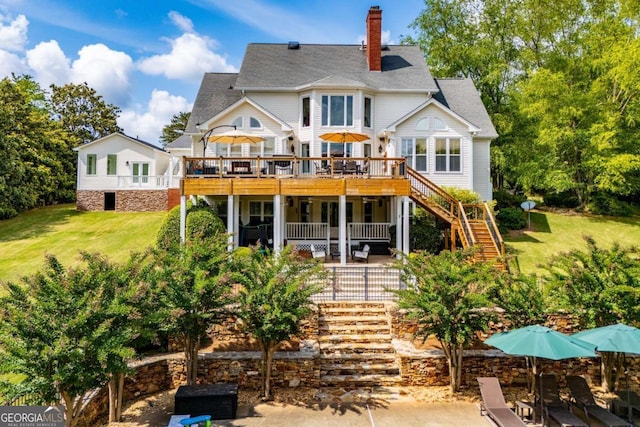 1745 Stripling Chapel Rd, Carrollton, GA 30116 - rear view of house with stairway, a yard, a wooden deck, and a chimney