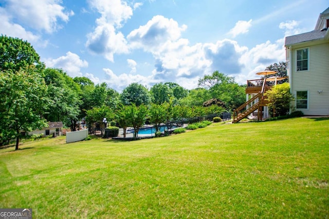 1745 Stripling Chapel Rd, Carrollton, GA 30116 - view of yard featuring a fenced in pool, fence, stairs, and a deck