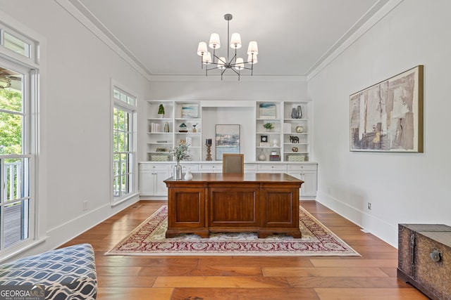 office area featuring crown molding, baseboards, a notable chandelier, and hardwood / wood-style flooring