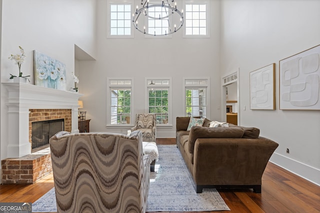 living area with plenty of natural light, a high ceiling, and dark wood finished floors