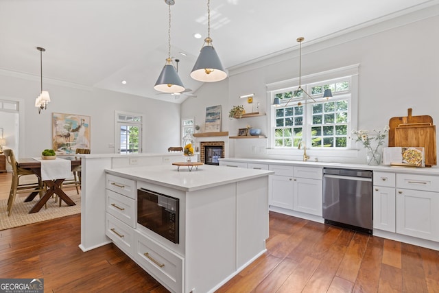kitchen featuring stainless steel dishwasher, a glass covered fireplace, black microwave, dark wood-style floors, and plenty of natural light