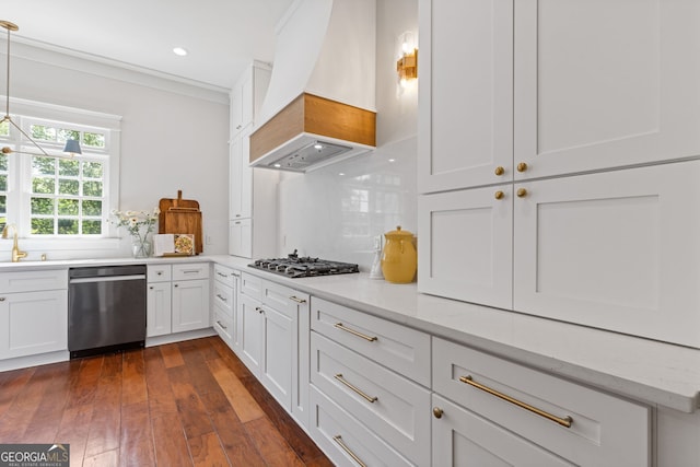 kitchen with backsplash, appliances with stainless steel finishes, dark wood finished floors, white cabinets, and custom range hood
