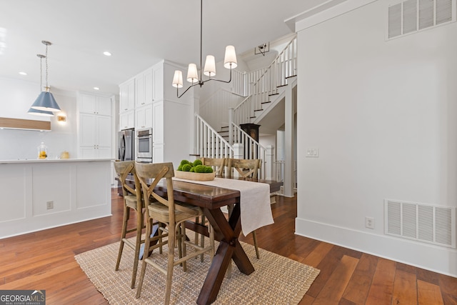 dining room featuring stairs, recessed lighting, visible vents, and hardwood / wood-style floors