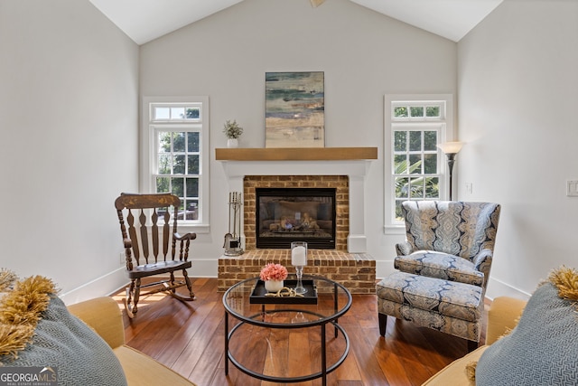 sitting room with a healthy amount of sunlight, baseboards, wood finished floors, and lofted ceiling