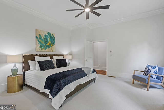 bedroom with baseboards, ornamental molding, a ceiling fan, and carpet floors