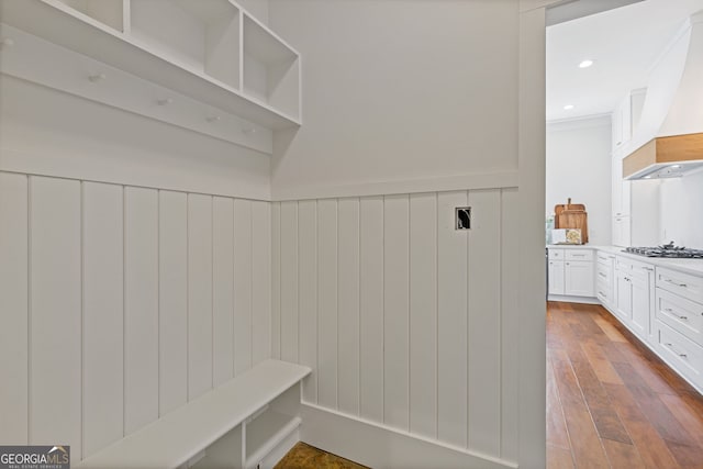 mudroom with wainscoting and hardwood / wood-style flooring
