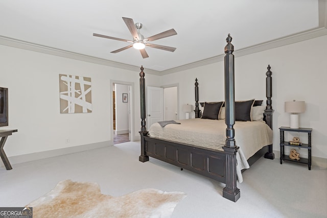 carpeted bedroom with crown molding, baseboards, and ceiling fan