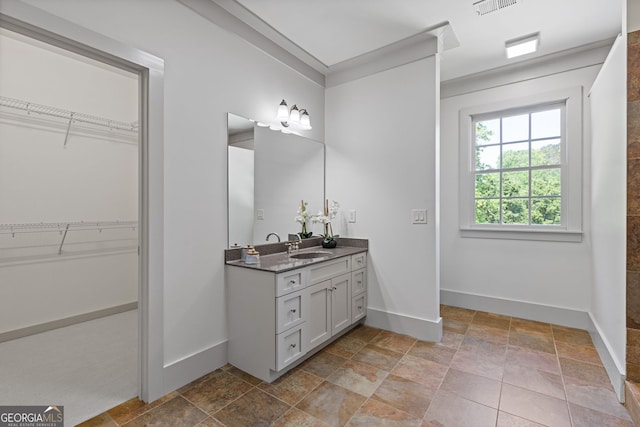 full bath with baseboards, stone finish flooring, visible vents, and vanity