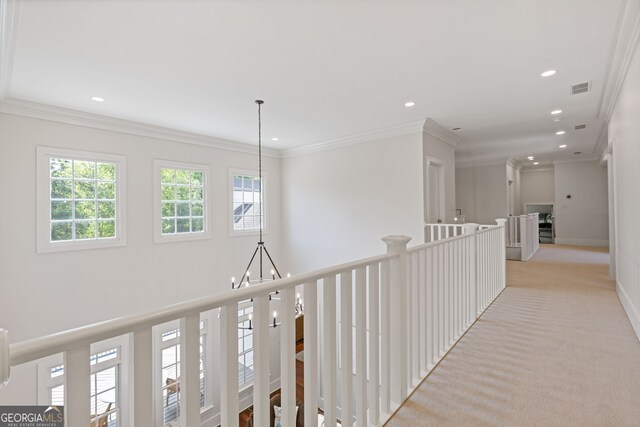 corridor featuring light colored carpet, recessed lighting, an upstairs landing, visible vents, and ornamental molding