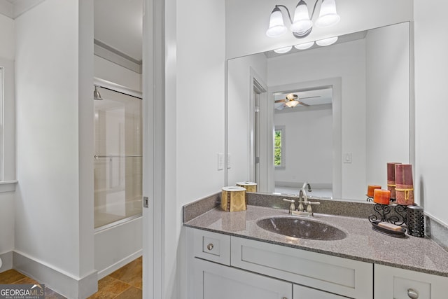 full bathroom featuring vanity, ceiling fan, and combined bath / shower with glass door