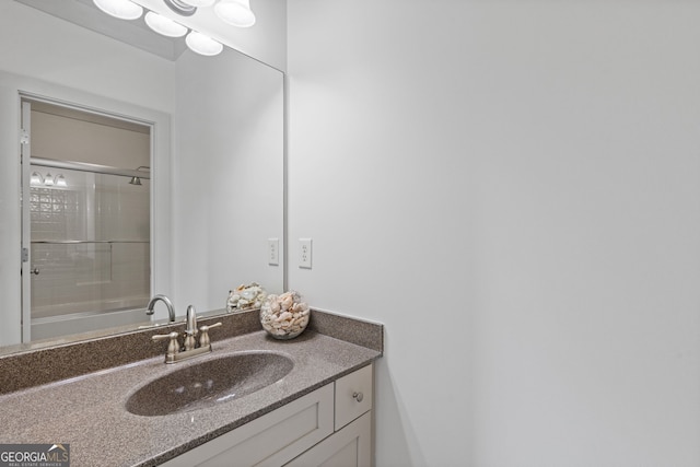 bathroom featuring vanity and an enclosed shower