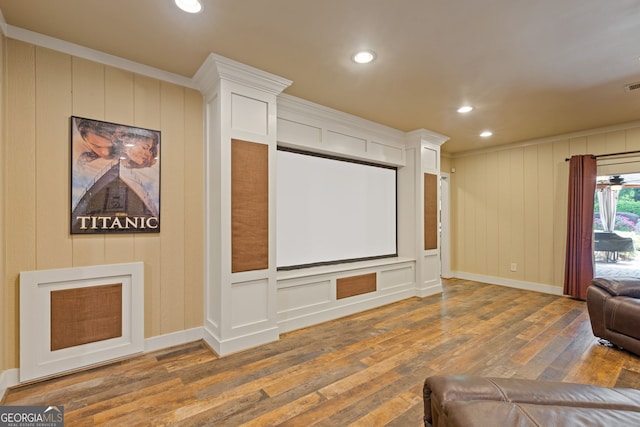 cinema room with a decorative wall, recessed lighting, baseboards, visible vents, and hardwood / wood-style flooring