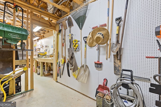 miscellaneous room featuring a workshop area and concrete floors