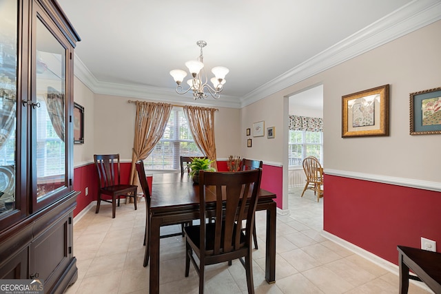 dining space with baseboards, ornamental molding, light tile patterned floors, and a notable chandelier