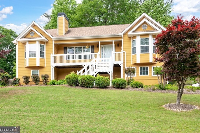 view of front facade featuring covered porch, a chimney, stairs, and a front yard