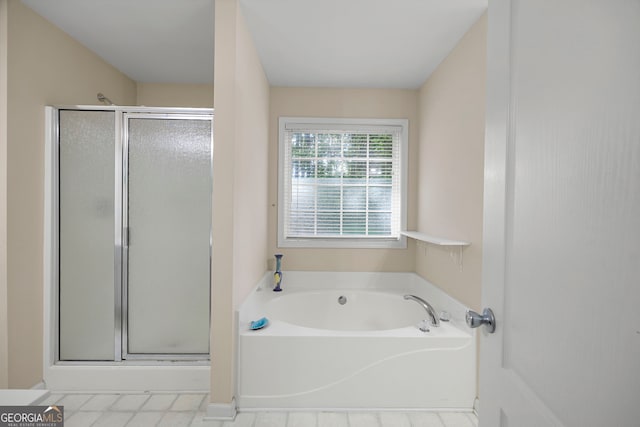 full bath with a shower stall and a garden tub