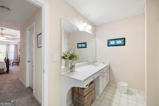 bathroom featuring connected bathroom, ceiling fan, baseboards, and vanity
