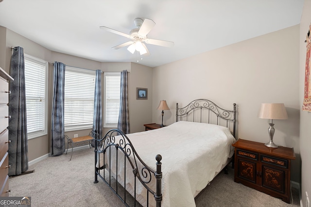 bedroom with carpet floors, multiple windows, baseboards, and ceiling fan