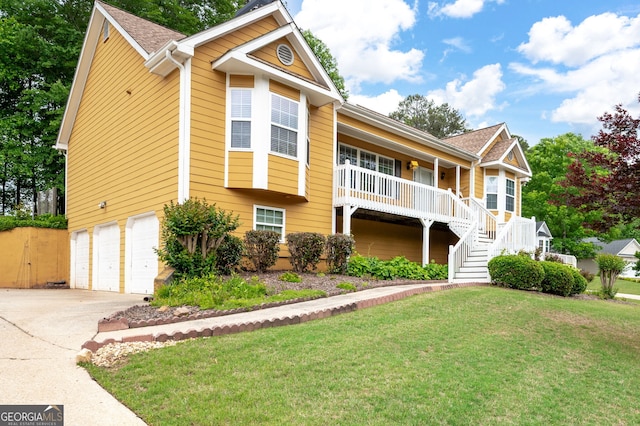 view of front of home with a garage, a front lawn, concrete driveway, a porch, and stairway