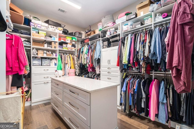 spacious closet featuring visible vents and wood finished floors