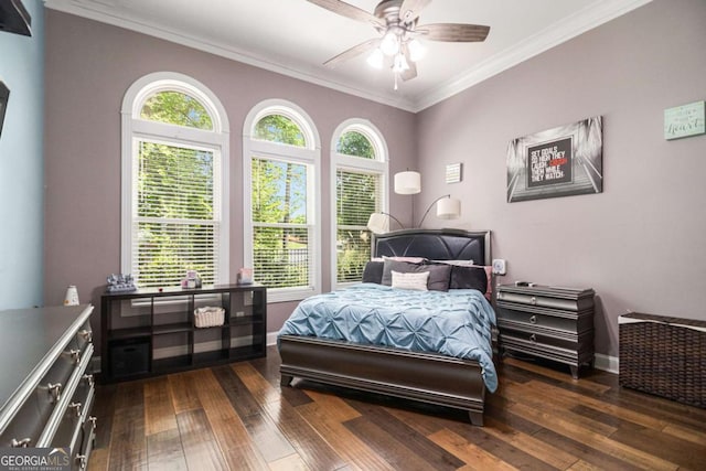 bedroom with crown molding, baseboards, and dark wood finished floors