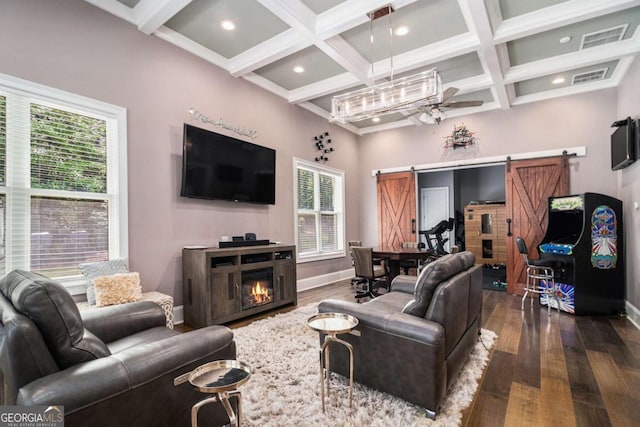 living room featuring dark wood-style floors, a barn door, and coffered ceiling