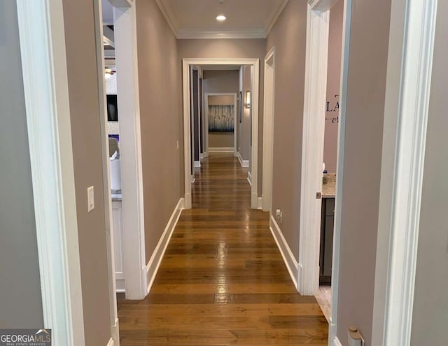 hall featuring wood-type flooring, recessed lighting, baseboards, and ornamental molding