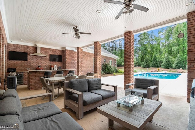 view of patio with area for grilling, a ceiling fan, and an outdoor hangout area