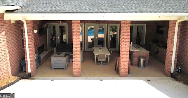 view of patio featuring french doors and an outdoor kitchen