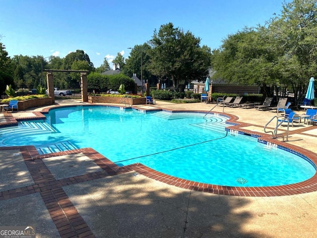 pool featuring a patio and fence