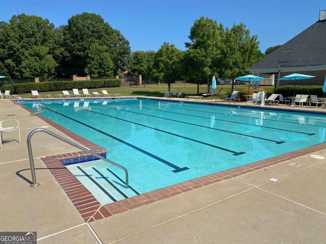 pool with fence and a patio