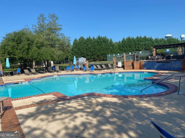 pool featuring fence and a patio