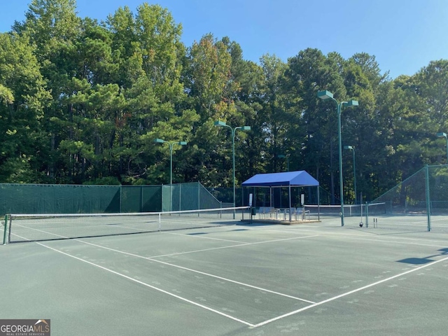 view of tennis court featuring fence