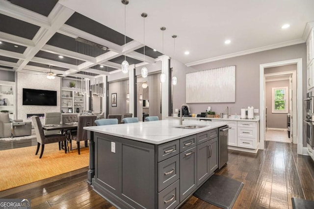 kitchen with open floor plan, dark wood-type flooring, a sink, dishwasher, and gray cabinetry