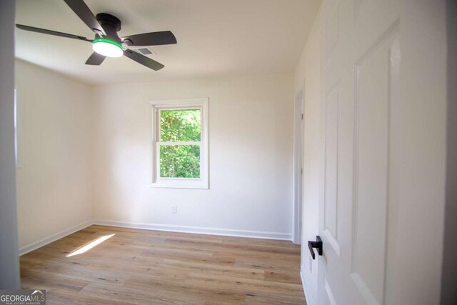 unfurnished room featuring baseboards, ceiling fan, and light wood-type flooring