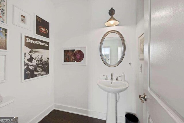 bathroom featuring baseboards and wood finished floors