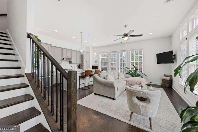 living room with recessed lighting, dark wood-style flooring, a ceiling fan, and stairs