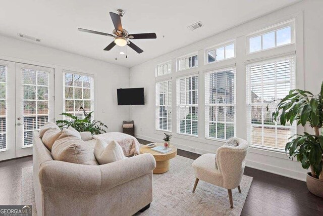 living room featuring visible vents, wood finished floors, a healthy amount of sunlight, and french doors